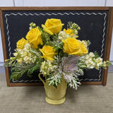 Yellow rose arrangement in vintage pottery