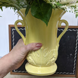 Yellow rose arrangement in vintage pottery